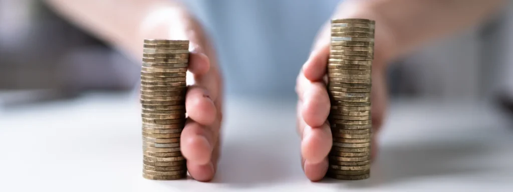 A pile of coins being divided to represent how finances are split during divorce settlements.
